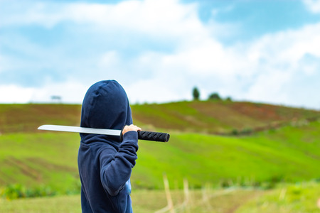 Portrait of a boy holding a wooden sword play.の写真素材