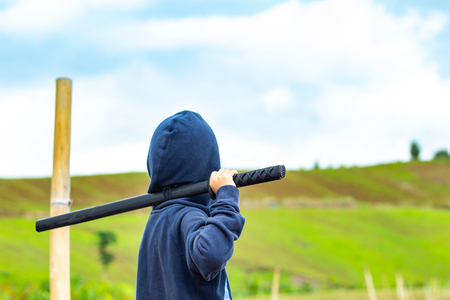 Portrait of a boy holding a wooden sword play.の写真素材