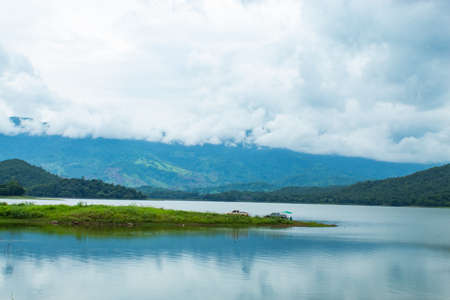 Fishermen sit fishing at the Huai Pa Daeng Reservoir , Phetchabun in  Thailand.の写真素材