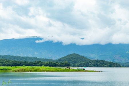 Fishermen sit fishing at the Huai Pa Daeng Reservoir , Phetchabun in  Thailand.の写真素材
