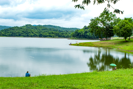 Fishermen sit fishing at the Huai Pa Daeng Reservoir , Phetchabun in  Thailand.の写真素材