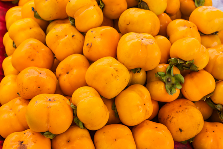 Fresh yellow persimmon Lot for saleの写真素材