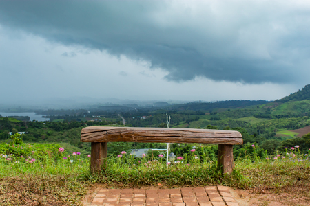 Chair on top of the mountain and the sky raining.の写真素材