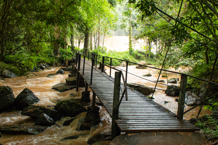 Wooden bridge crossing the Brook at Si Dit waterfall , Phetchabun in Thailand.の写真素材