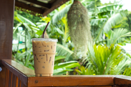 Iced coffee on a wooden  in the garden.の写真素材