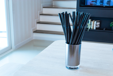 Drinking straw black in glass stainless steel on the table.の写真素材