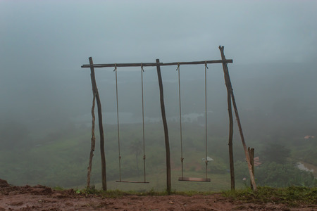 Swing chair wood on the mountain with fog.の写真素材
