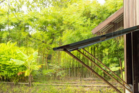 Raining window open, using bamboo poles to propの写真素材