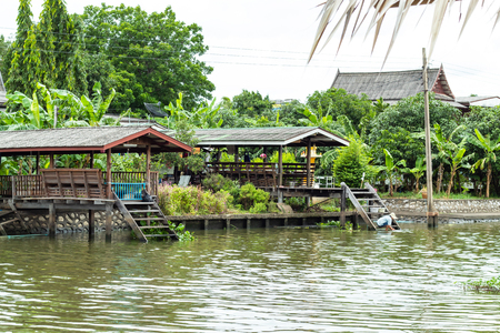 Classical wooden Thai House along the canal.の写真素材
