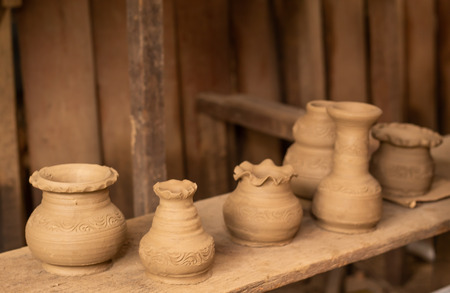Clay vase placed on the wood to dry before the fireの写真素材
