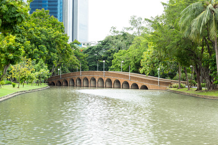 Concrete bridge crossing the pond In a public park.の写真素材