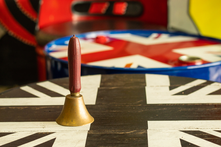Bell brass wooden handle on wooden table.の写真素材