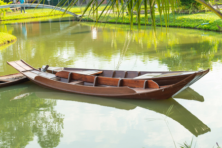 Wooden boat floating in nature water.の写真素材