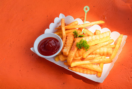 French fries and tomato sauce in the paper box.の写真素材