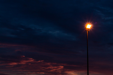 Street light that illuminates the sunset light.の写真素材