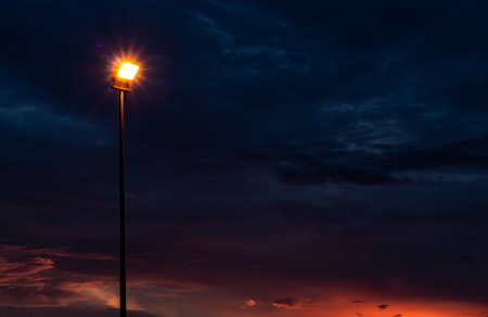 Street light that illuminates the sunset light.の写真素材