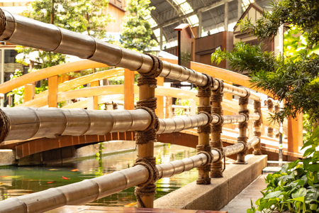 The fence is made from bamboo and a Cranberry fish pond.の写真素材