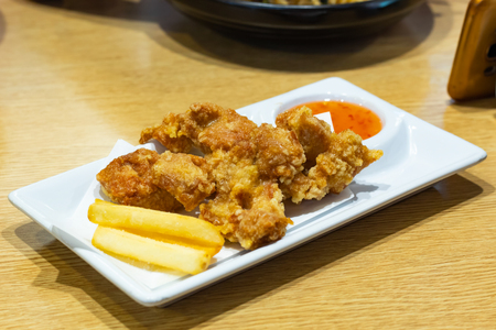 Fried chicken and french fries on a plate.の写真素材