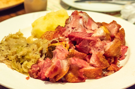 German pork fried with vegetables on a white plateの写真素材