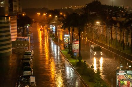 The rain was heavy on city streets at night, Muang Thong Thani, Nonthaburi in Thailand. 20 October 2018.のeditorial素材