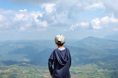 Asian boys see the mountains and the sky.の写真素材