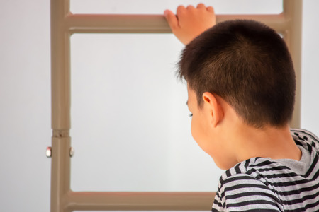 Portrait of Asian boys are climbing the ladder in the playground.