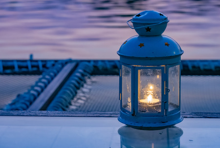 Candle fires are contained in the lamps , Placed on the table.の写真素材