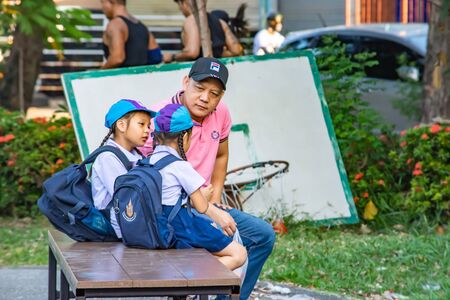The girl talking with my father before school in the BangYai park, Nonthaburi in Thailand. December 3, 2018のeditorial素材