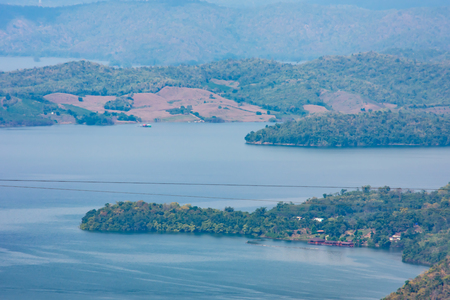 The beauty inside the dam and the houseboat on the bright sky at Sri Nakarin dam , Kanchana buri in Thailand.の写真素材