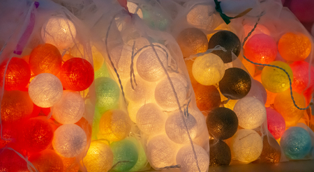 Light bulbs are in the circular thread with multiple colors.の写真素材