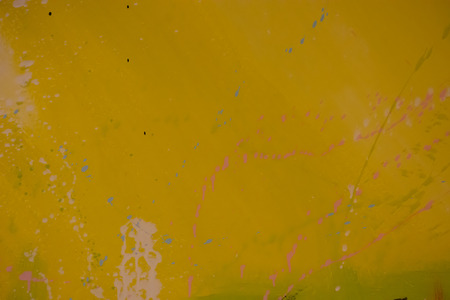 Yellow cement wall with dripping paint stains Used as background.の写真素材