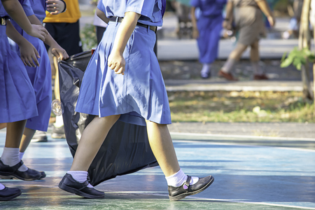 Hand Asean girl holding Black garbage bags.の写真素材