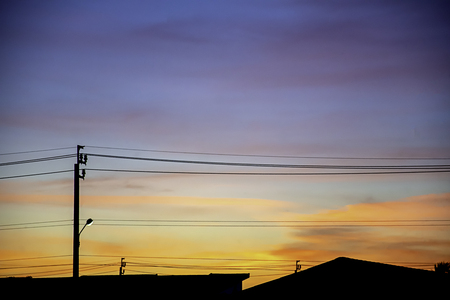 Beautiful light of Sunset with clouds in the sky reflection behind the building.の写真素材