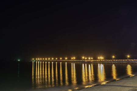The lights on the bridge at night Background Sea  at Prachuap Bay in Thailand.の写真素材