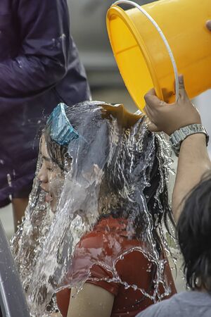 Asian woman Riding a motorcycle play water in Songkran festival or Thai new year in Thailand at Bang kruai, Nonthaburi, April 15, 2019のeditorial素材