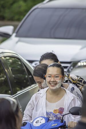 Asian woman Riding a motorcycle play water and flour in Songkran festival or Thai new year in Thailand at Bang kruai, Nonthaburi, April 15, 2019のeditorial素材