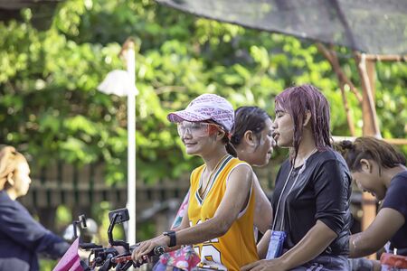 Asian woman Riding a motorcycle play water and flour in Songkran festival or Thai new year in Thailand at Bang kruai, Nonthaburi, April 15, 2019のeditorial素材