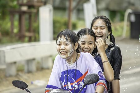 Asian woman Riding a motorcycle play water and flour in Songkran festival or Thai new year in Thailand at Bang kruai, Nonthaburi, April 15, 2019のeditorial素材
