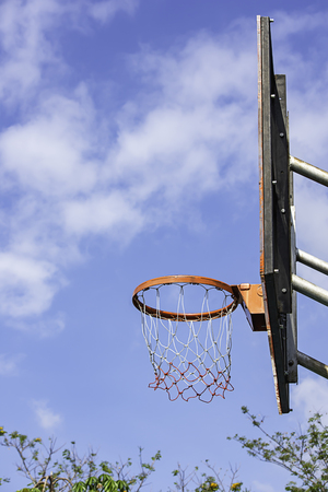 Basketball hoop background blurry tree and the sky.の写真素材