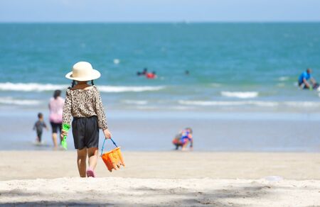 The image behind girl is walking on the beach Background sea at Suan Son  Pradipat Beach , Prachuap Khiri Khan in Thailand.の写真素材