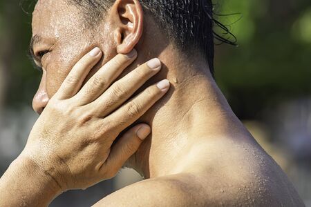The hand grips the neck that inflammation from a sports injury.の写真素材