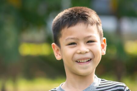 Portrait of a boy Asia, laughing and smiling happily in the park.の写真素材
