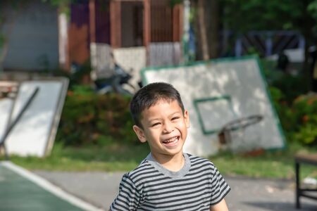 Portrait of a boy Asia, laughing and smiling happily in the park.の写真素材