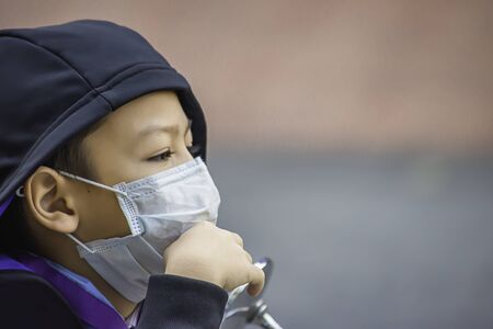 Boys wear a mask to prevent dust in Bangkok ,Thailand.の写真素材