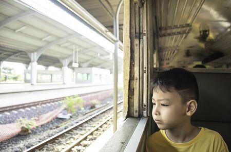 Portrait of a boy on the train Looking outside the window views