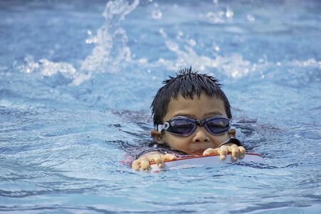boys are swimming in the pool.の写真素材