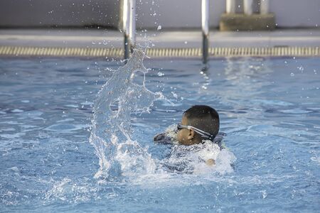 boys are swimming in the pool.の写真素材