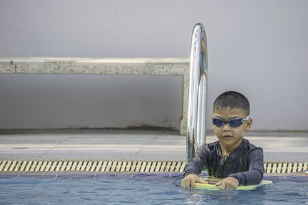 boys are swimming in the pool.の写真素材