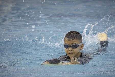 boys are swimming in the pool.の写真素材