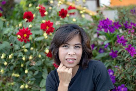 Portrait Asian woman With red flowers And purple flowersの写真素材